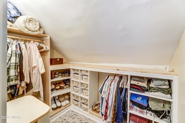 walk in closet featuring vaulted ceiling