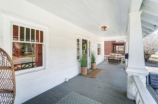 wooden terrace featuring covered porch