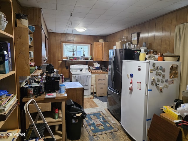 kitchen featuring brown cabinetry, white appliances, wooden walls, and light countertops