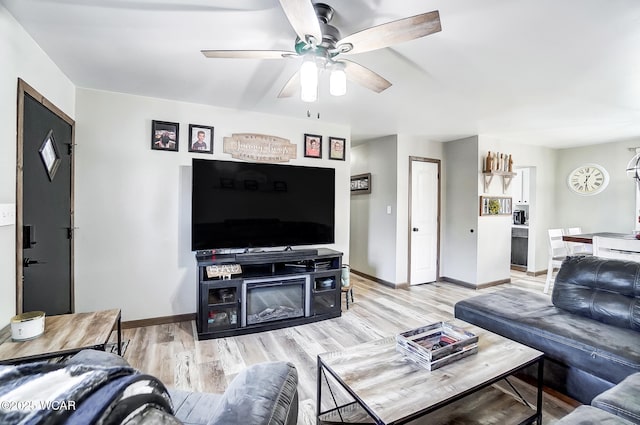 living room with light hardwood / wood-style floors and ceiling fan