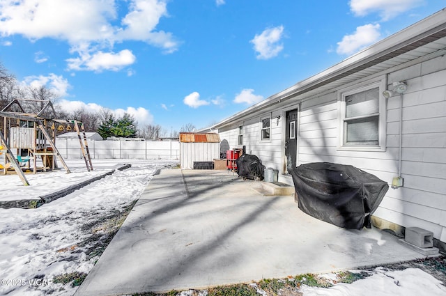 view of yard featuring a playground and a patio