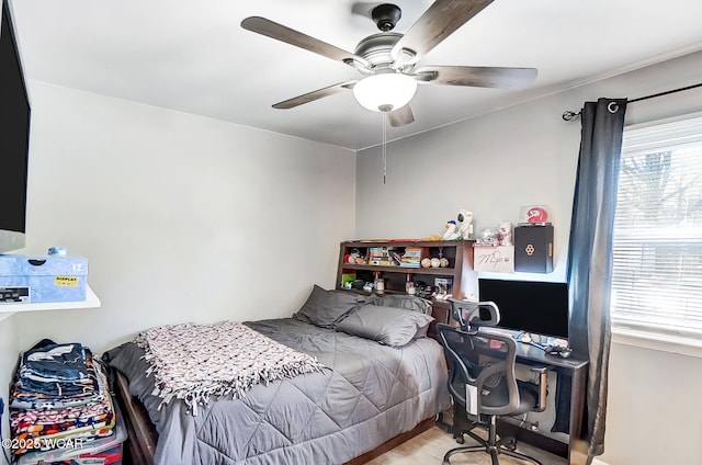 bedroom featuring ceiling fan and multiple windows