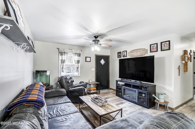 living room featuring hardwood / wood-style floors and ceiling fan