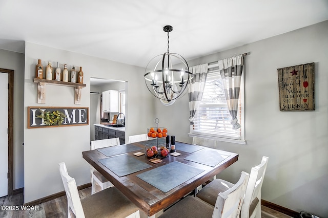 dining area featuring dark hardwood / wood-style floors, sink, and a chandelier