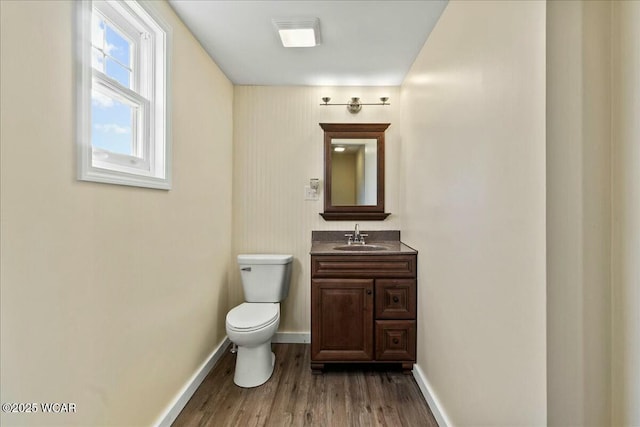 bathroom featuring hardwood / wood-style flooring, vanity, and toilet