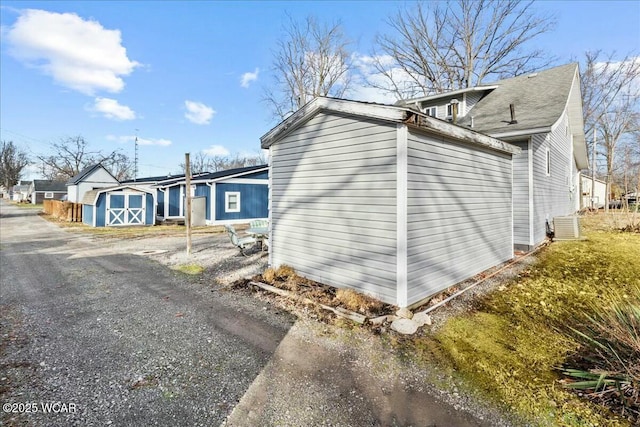 view of side of home with a storage unit