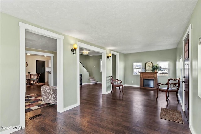 sitting room featuring dark hardwood / wood-style flooring and a textured ceiling