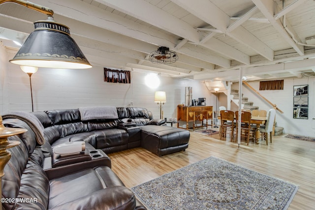 5065 Amherst Rd, Lima, OH 45806 - living area with stairs, wood finished floors, concrete block wall, and beam ceiling