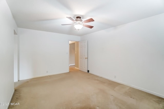 unfurnished room with light carpet, ceiling fan, and baseboards