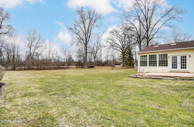 view of yard with a patio and french doors