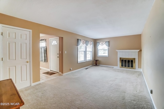 unfurnished living room featuring visible vents, a fireplace, baseboards, and carpet flooring