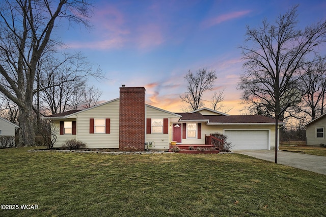 view of front facade with an attached garage, a chimney, concrete driveway, and a front yard