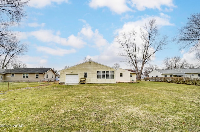 back of house featuring a lawn and fence