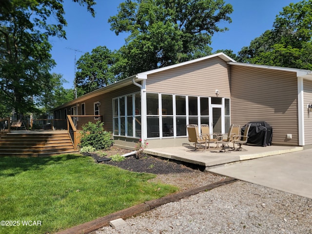3139 Clifford Dr, Lima, OH 45805 - rear view of house featuring a wooden deck, a patio area, a sunroom, and a lawn