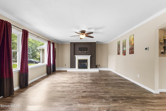 3139 Clifford Dr, Lima, OH 45805 - unfurnished living room with ceiling fan, wood finished floors, a fireplace with raised hearth, and ornamental molding