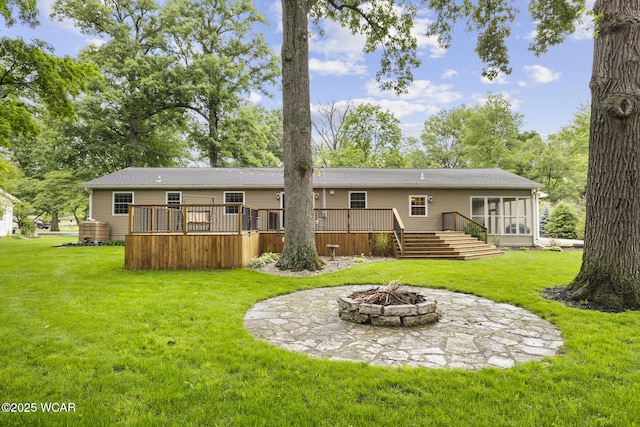 3139 Clifford Dr, Lima, OH 45805 - back of property with an outdoor fire pit, a deck, a lawn, and stairs