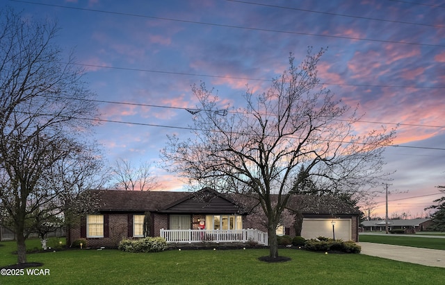 5295 E Rd, Lima, OH 45807 - single story home featuring covered porch, driveway, brick siding, and a yard