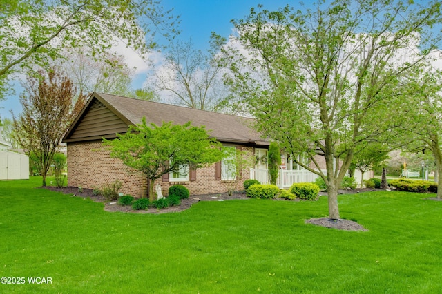 5295 E Rd, Lima, OH 45807 - view of front of property featuring a storage unit, an outdoor structure, a front lawn, and brick siding