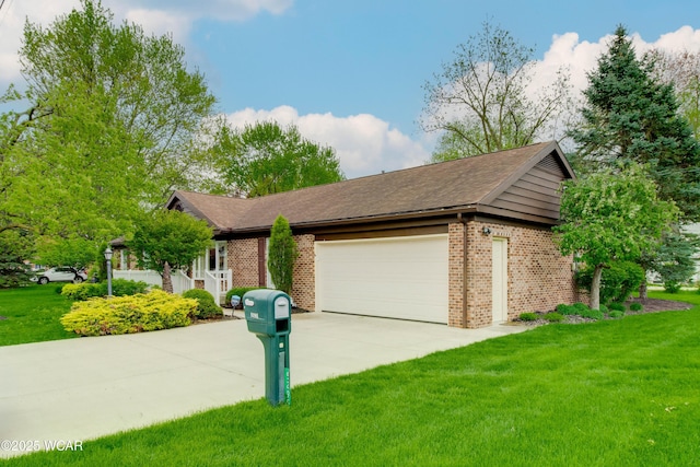 5295 E Rd, Lima, OH 45807 - ranch-style house with brick siding, a garage, driveway, and a front yard