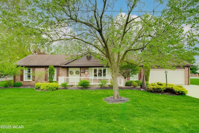 5295 E Rd, Lima, OH 45807 - ranch-style home featuring brick siding, a front lawn, driveway, and a porch