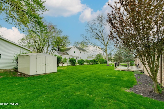 5295 E Rd, Lima, OH 45807 - view of yard with an outdoor structure, a wooden deck, and a storage shed