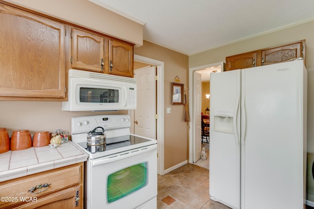 5295 E Rd, Lima, OH 45807 - kitchen with tile counters and white appliances