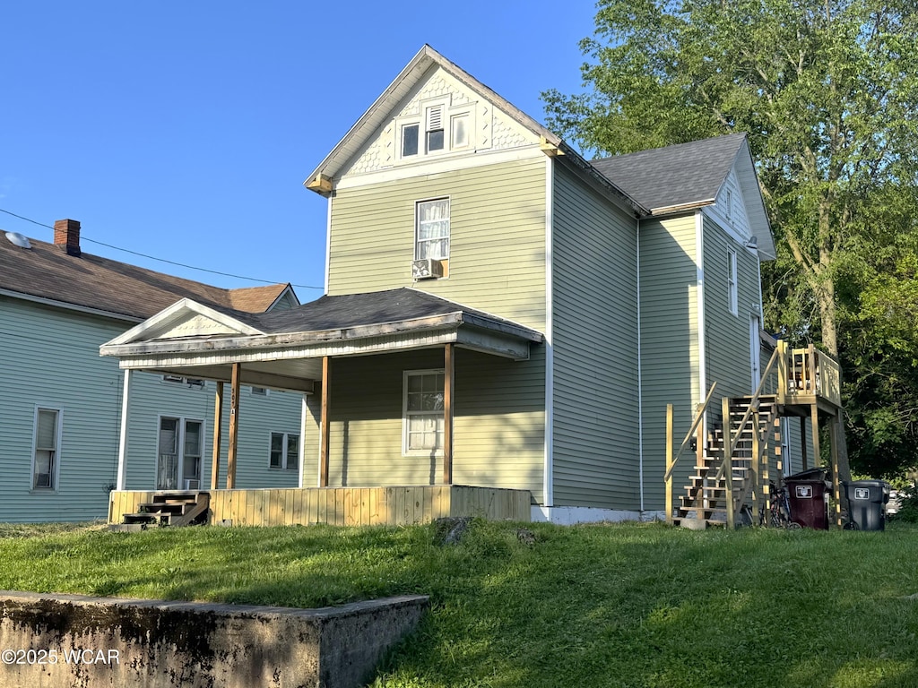 307 Harrison Ave, Lima, OH 45804 - rear view of house featuring stairway, a lawn, and roof with shingles