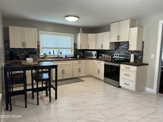 400 N Westminster St, Waynesfield, OH 45896 - kitchen with stainless steel appliances, decorative backsplash, and dark countertops