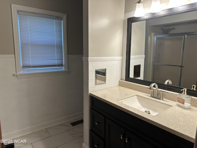 400 N Westminster St, Waynesfield, OH 45896 - full bath with marble finish floors, vanity, a stall shower, wainscoting, and tile walls