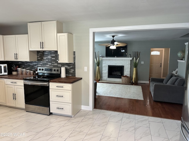 400 N Westminster St, Waynesfield, OH 45896 - kitchen with stainless steel appliances, open floor plan, a ceiling fan, and light marble finish floors