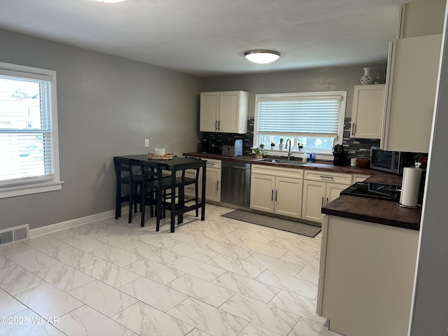 400 N Westminster St, Waynesfield, OH 45896 - kitchen featuring stainless steel appliances, backsplash, and plenty of natural light