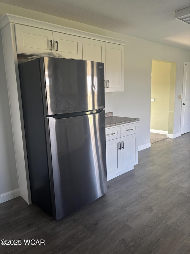 25853 Rd M, Cloverdale, OH 45827 - kitchen featuring freestanding refrigerator, white cabinets, and dark wood finished floors