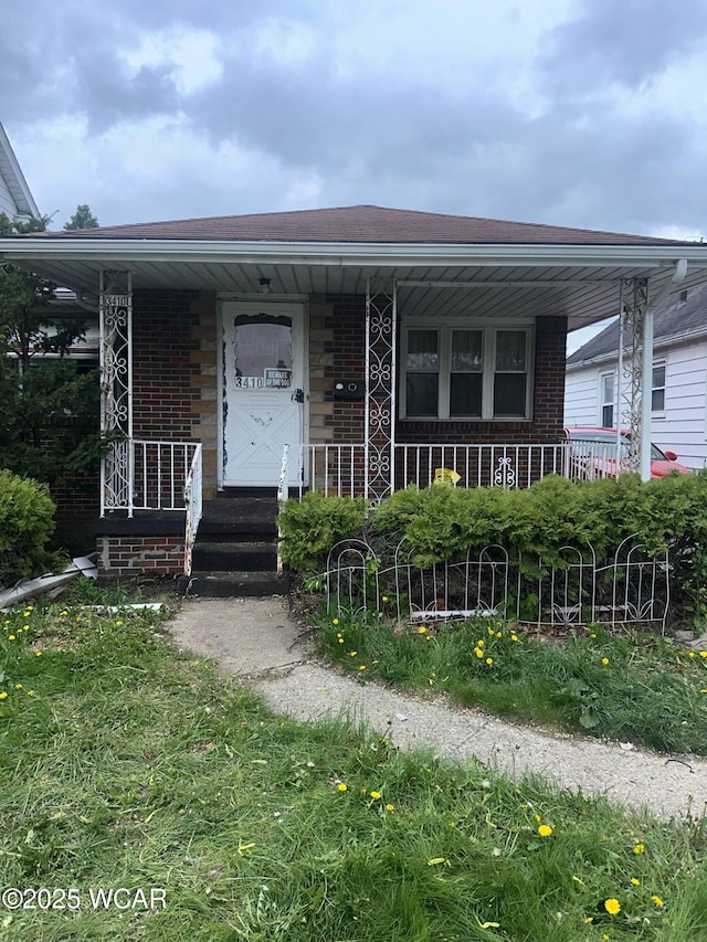 view of front of property with brick siding and covered porch