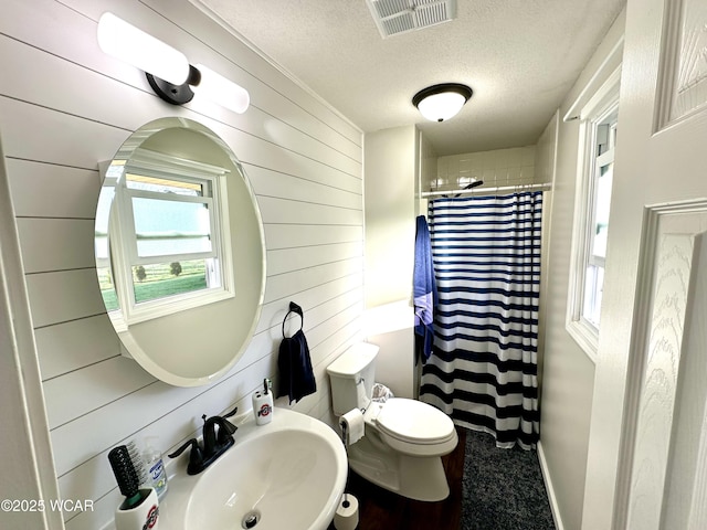 305 Fenway Dr, Lima, OH 45804 - full bathroom with plenty of natural light, a textured ceiling, wooden walls, and a shower with curtain