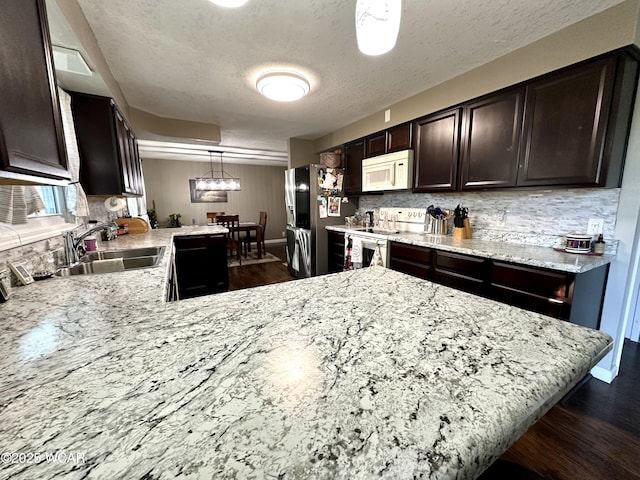 305 Fenway Dr, Lima, OH 45804 - kitchen featuring white appliances, dark brown cabinets, tasteful backsplash, a textured ceiling, and dark wood-style flooring