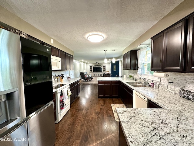 305 Fenway Dr, Lima, OH 45804 - kitchen with white appliances, open floor plan, a peninsula, dark brown cabinetry, and a textured ceiling