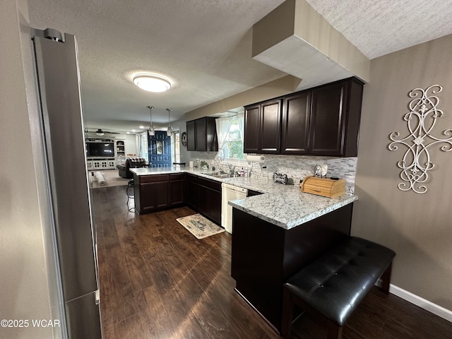 305 Fenway Dr, Lima, OH 45804 - kitchen featuring a peninsula, a textured ceiling, freestanding refrigerator, dishwashing machine, and dark wood-style flooring