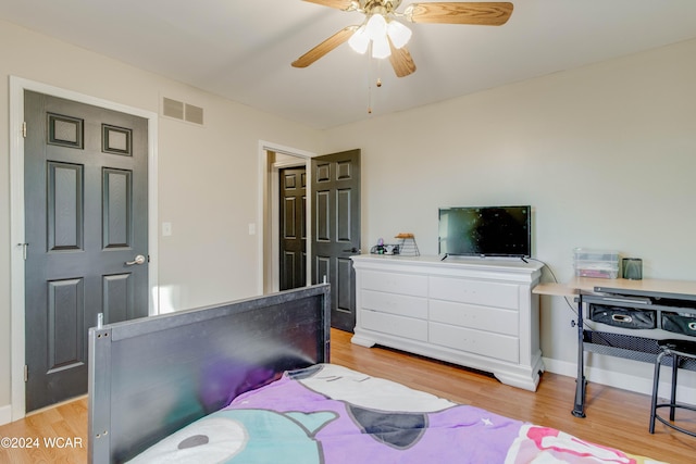 bedroom with light hardwood / wood-style floors and ceiling fan