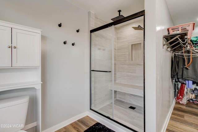 bathroom with walk in shower, wood-type flooring, and toilet