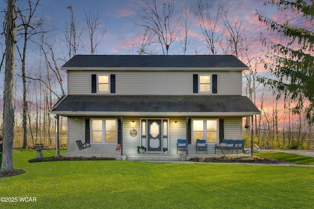 view of front of home with a lawn and covered porch