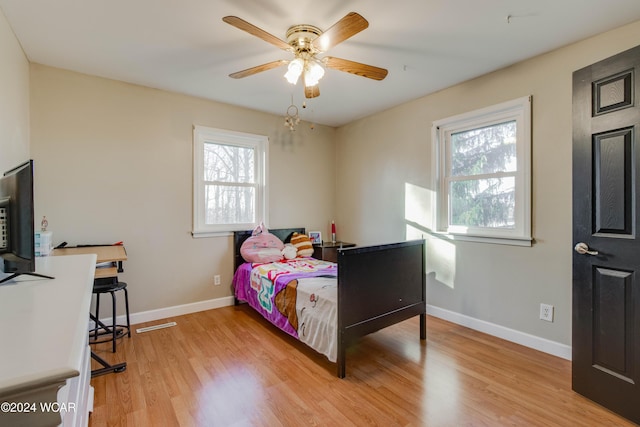 bedroom with ceiling fan and light hardwood / wood-style flooring