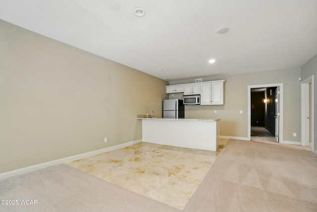 4441 Indian Hill Dr, Lima, OH 45806 - kitchen featuring appliances with stainless steel finishes, light carpet, white cabinets, baseboards, and recessed lighting