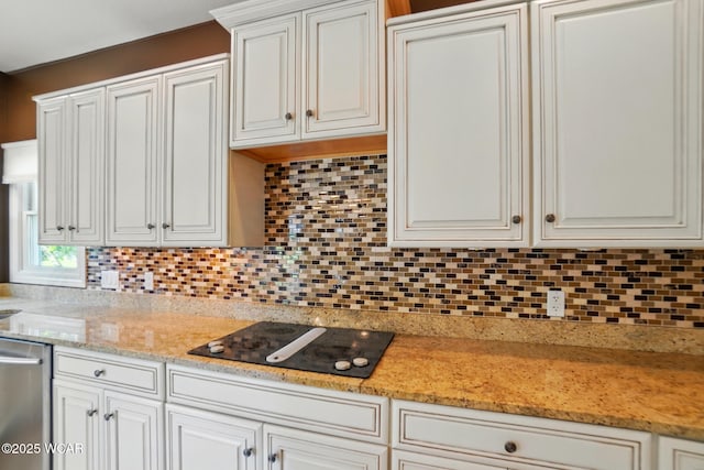 4441 Indian Hill Dr, Lima, OH 45806 - kitchen featuring black electric cooktop, tasteful backsplash, stainless steel dishwasher, and white cabinetry