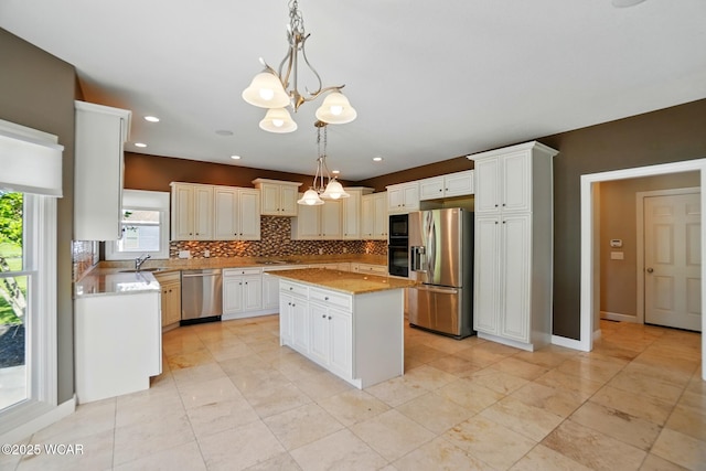4441 Indian Hill Dr, Lima, OH 45806 - kitchen featuring black appliances, a chandelier, a sink, backsplash, and a kitchen island