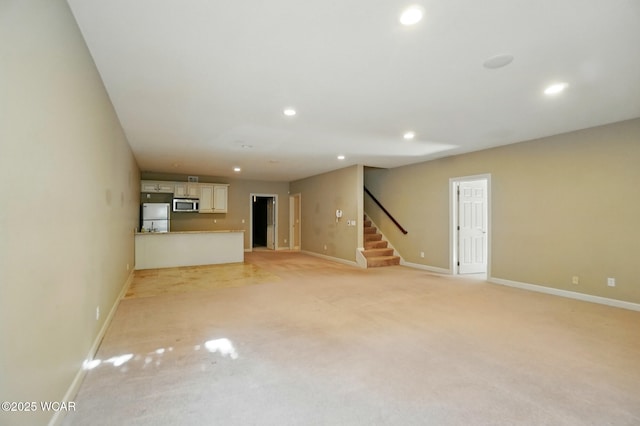 4441 Indian Hill Dr, Lima, OH 45806 - unfurnished living room with recessed lighting, baseboards, stairway, and light carpet