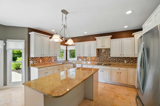 4441 Indian Hill Dr, Lima, OH 45806 - kitchen with appliances with stainless steel finishes, a center island, decorative backsplash, recessed lighting, and pendant lighting