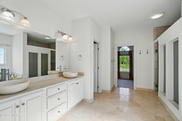 4441 Indian Hill Dr, Lima, OH 45806 - bathroom with a stall shower, double vanity, and baseboards