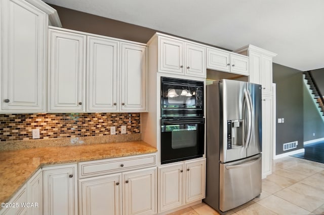 4441 Indian Hill Dr, Lima, OH 45806 - kitchen with black appliances, light tile patterned floors, decorative backsplash, and white cabinets