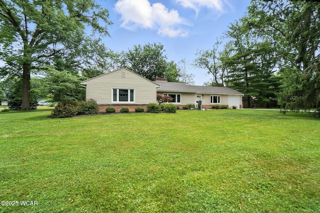 2619 Wendell Ave, Lima, OH 45805 - ranch-style home featuring a garage, a front lawn, brick siding, and a chimney
