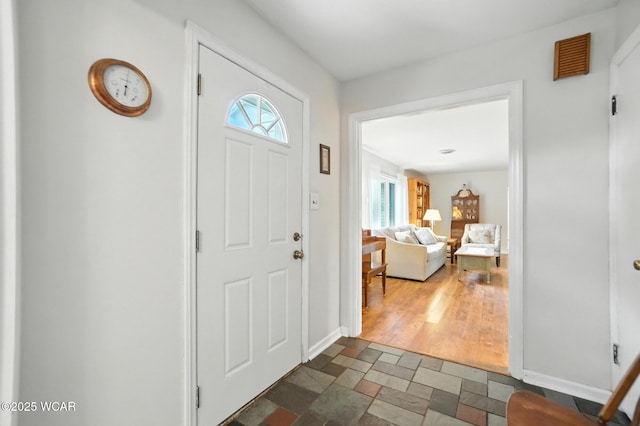 2619 Wendell Ave, Lima, OH 45805 - entryway featuring dark stone finish flooring and baseboards